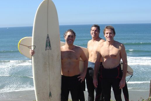 three-guys-on-beach-with-surfboards